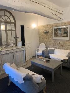 a living room with a couch and a table at Bleu D'Orage in Vimoutiers