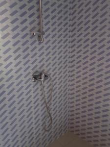 a shower with a shower head in a bathroom at La maison Yaka in Boukot Ouolof