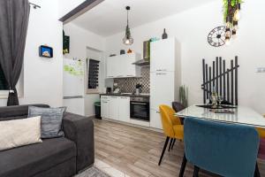 ein Wohnzimmer und eine Küche mit einem Sofa und einem Tisch in der Unterkunft Spacious Apartment Center in Split