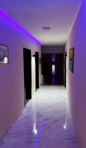 an empty hallway with purple lights on the walls at Hotel Casablanca in Goražde