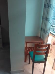 a wooden table and a chair in a room at HOTEL REAL PALACE CHURIN in Churín