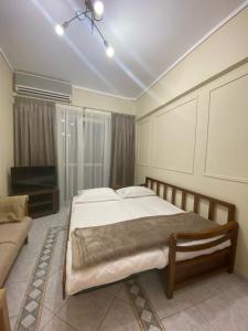um quarto com uma cama grande e um sofá em Sunny Suite em Perea