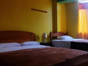 Postel nebo postele na pokoji v ubytování Hostal Kollarón