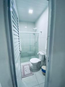 a bathroom with a toilet and a glass shower at BL Maria Bonita Pousada in Maragogi