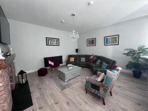 a living room with a couch and a table at The Old School House *New* in Coagh +23 photos