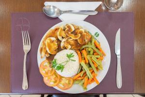 a plate of food with vegetables on a purple table at Hotel Golden Park Campinas Viracopos By Nacional Inn in Campinas