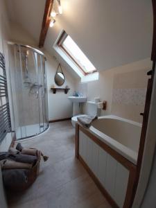 a bathroom with a tub and a shower and a sink at Meadowbeck Holiday Cottages in Whitby