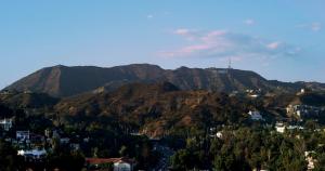 a view of a mountain range with a town and houses at Loews Hollywood Hotel in Los Angeles