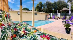 a pool in front of a house with a couch at Studio Romance in Carnoules