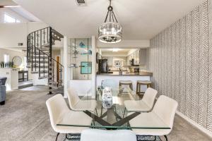 a dining room with a glass table and white chairs at Shalimar Townhome with Screened Porch 6 Mi to Beach in Shalimar