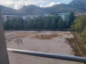 a construction site with trees and buildings and mountains at Milica in Trebinje
