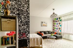a living room with a black and white patterned wall at Studio: Alex’s secret! in Pori
