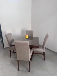 a dining room table with two chairs and a lamp at Porteño Abode in Veracruz