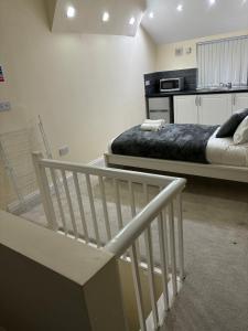 a bedroom with two beds and a stair case at Coventry Large Sleeps 5 Person 4 Bedroom 4 Bath House Suitable for BHX NEC Solihull Rugby Warwick Contractors Ricoh Arena NHS Short & Long Business Stays Free Parking for 2 Vehicles, Close to City Centre High Speed Wifi in Coventry