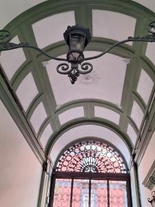 a chandelier in a building with a stained glass window at B&B Museum in Naples