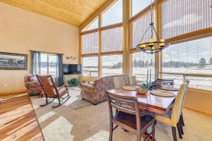 a living room with a table and a couch at Cozy Duck Creek Village Cabin with Hot Tub and Views! in Duck Creek Village