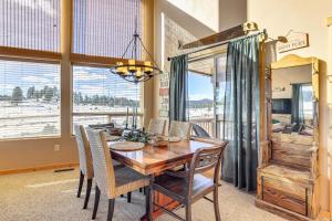 a dining room with a wooden table and chairs at Cozy Duck Creek Village Cabin with Hot Tub and Views! in Duck Creek Village