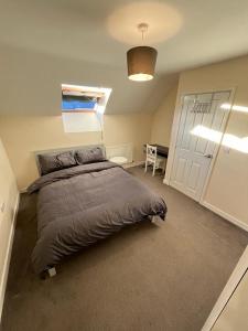 a bedroom with a large bed and a desk at Central Birmingham in Birmingham
