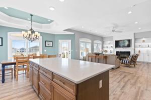 a kitchen and living room with a table and chairs at All the Views Ocean Isle Beach, heated private pool, close to beach in Ocean Isle Beach