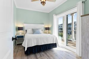 a white bedroom with a bed and a window at All the Views Ocean Isle Beach, heated private pool, close to beach in Ocean Isle Beach +62 photos