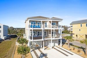 a large white house with palm trees in front of it at All the Views Ocean Isle Beach, heated private pool, close to beach in Ocean Isle Beach