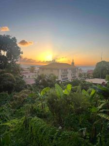 a view of a building with the sunset in the background at Case Louis et spa in Saint-Pierre +8 photos