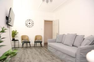 a living room with a couch and two chairs at Star London Golders Rise Luxury 4-Bed Oasis with Garden in Hendon