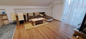 a living room with a couch and a table at Libertas Apartments in Bitola