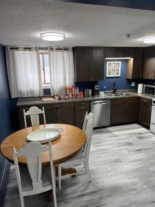a kitchen with a wooden table and chairs in a kitchen at Entire level just off Interstate, free breakfast in Fargo