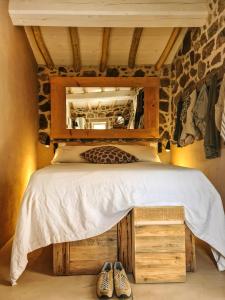 a bedroom with a bed with a mirror and shoes at Casa nel Bosco, un oasi di pace in Seccheto