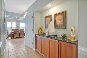 a living room with a counter with vases on it at Ain`t It The Life Brunswick Vacation Rentals in Ocean Isle Beach