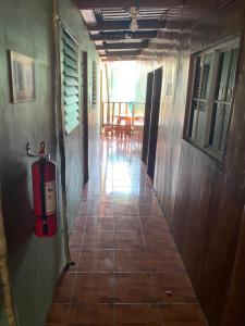 a hallway of a house with a fire extinguisher at Hotel Pacific Surf Room with AC best place in Tunco in Tamanique