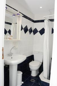 a bathroom with a white toilet and a sink at Aegean White Aparts in Naxos Chora +35 photos