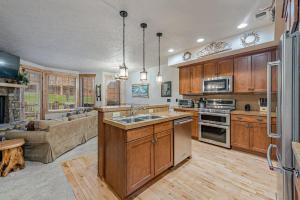 a kitchen with a sink and a couch in a room at Southwinds Ultimate Slope Side Relaxation Spot in Champion