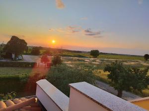 a view of a sunset from the balcony of a house at Nika's Sea View Oasis in Seget