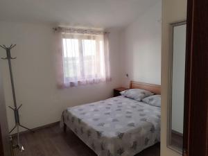 a bedroom with a bed and a window at Nika's Sea View Oasis in Seget