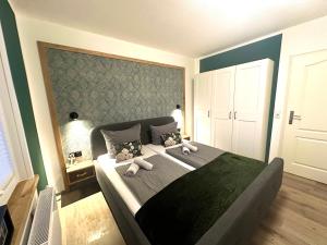 a bedroom with a large bed with two pillows at Auszeit Norddeich in Norddeich