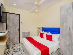 a bedroom with a large bed with red pillows at Hotel Good Luck Residency- Near Nesco in Mumbai