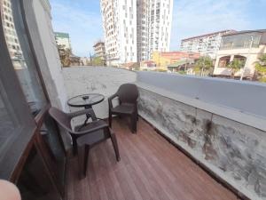a patio with two chairs and a table on a balcony at Aragvi in Batumi