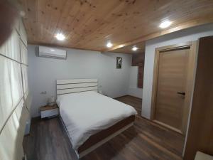 a small bedroom with a bed and a door at Aragvi in Batumi