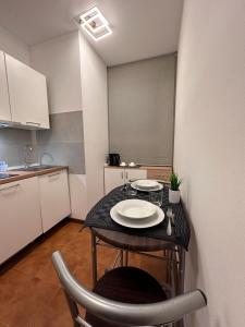a small kitchen with a table with plates on it at ROMA HOME in Udine
