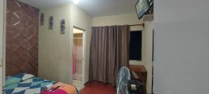 a bedroom with a bed and a desk and a window at Hotel Villas de San Juan, Guatemala in Guatemala