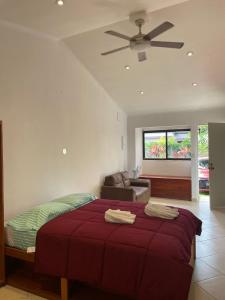 a bedroom with a bed and a ceiling fan at Vista Boquete Apartments in Bajo Boquete