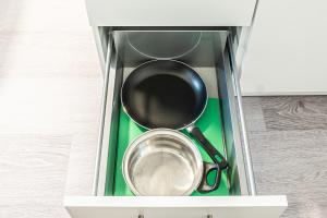 a frying pan and a pot in a drawer at Urban Oasis with Queen Bed and View BE-13 in Zürich +2 photos
