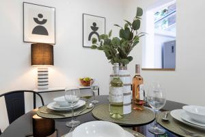 a dining room table with glasses and a bottle of wine at Urban Chic in Hartlepool