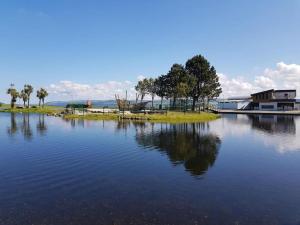 a large body of water with a house and trees at HollyJess Hoose in Stranraer