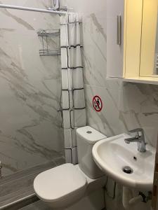 a bathroom with a toilet and a sink at Brand new studios Η1-Η2-Η3 in Larisa