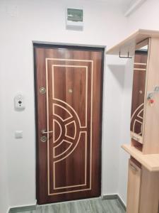 a wooden door with a design on it in a room at Feel Like Home in Piatra Neamţ