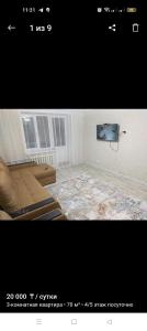 een foto van een woonkamer met een bank bij Уютная 3-х комнатная квартира in Oral