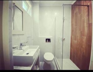 a bathroom with a shower and a toilet and a sink at Abi Mykonos in Mamaia Nord